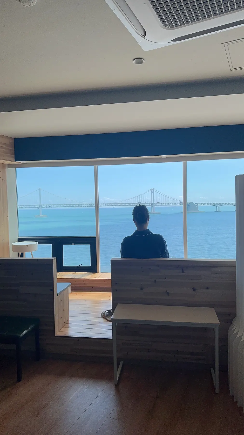 Guest looking toward Gwangan Bridge and the Gwangalli sea from Prada Spa